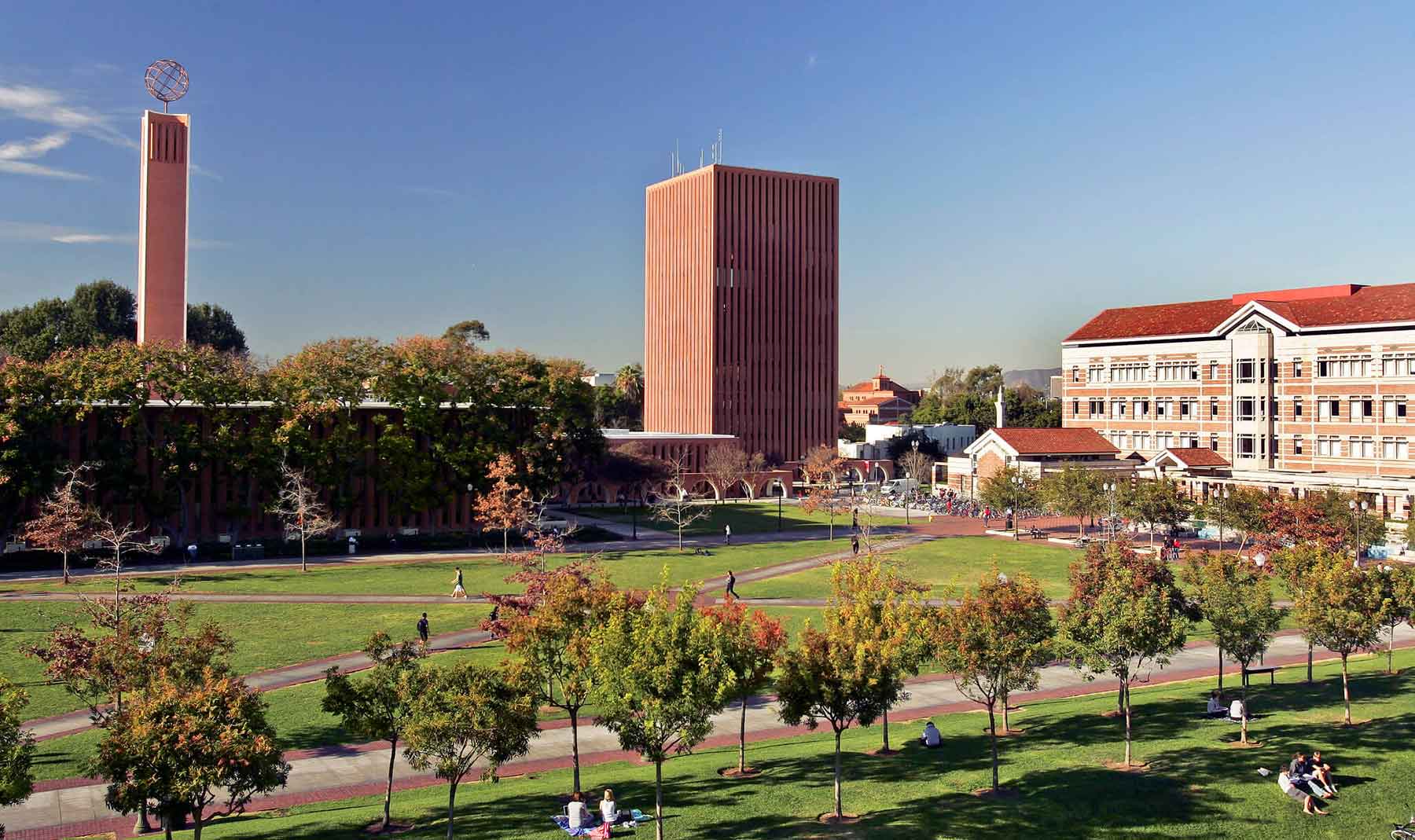 scenic view of USC's McCarthy Quad, with Leavy Library on the right and the red brick towers of the Rossier School and the Dr. Joseph Medicine Crow building in the background