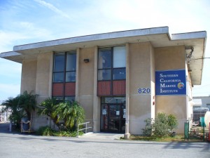the Southern California Marine Institute, a tan stucco two-story building with a flat roof and two columns of windows on the front facade