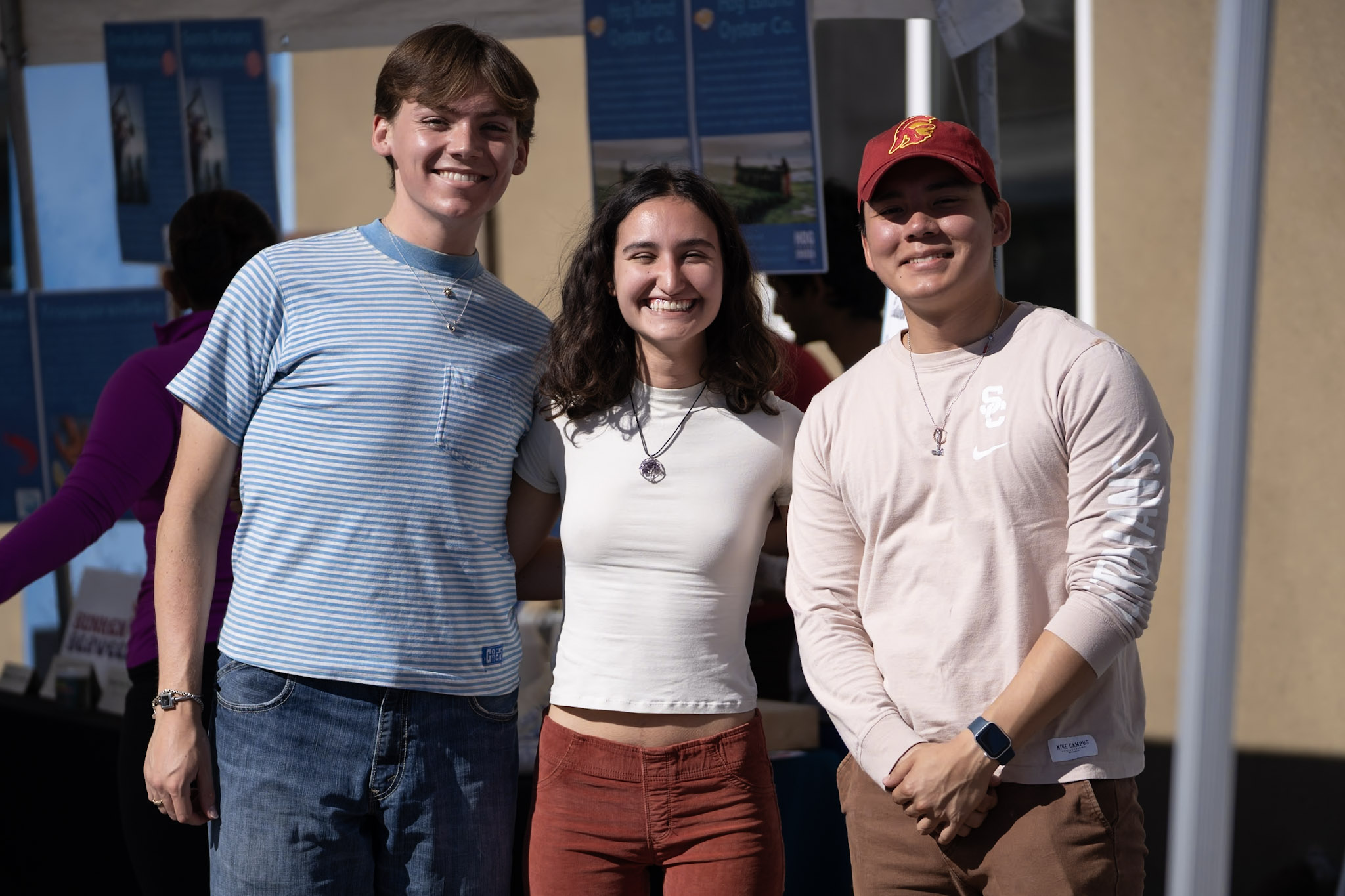 three usc students smile at the camera