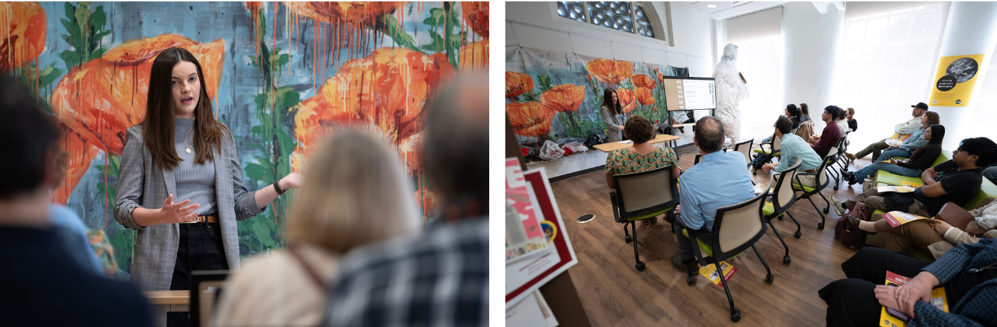 a PhD student presents to an audience against a backdrop of a mural of painted flowers